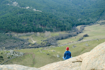 Fototapeta na wymiar A Woman in hat and jacket meditating on mountains