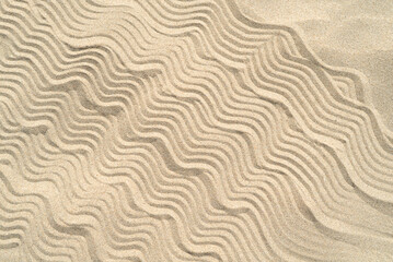 Texture of sea sand background closeup with ornament