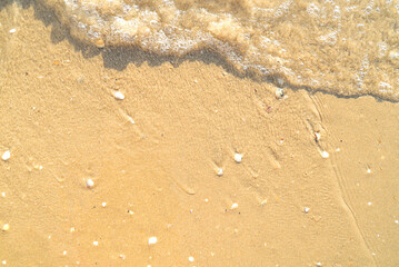Sand with stones and sea water top view background