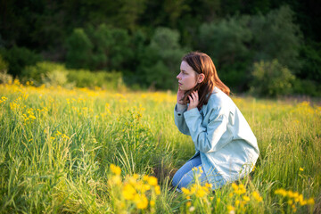 Portrait of confident young woman sitting in field