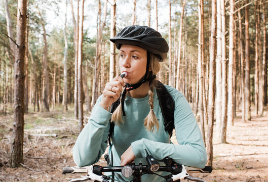 woman drinking from a bladder whilst out cycling in the forest