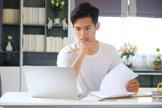 Young man working and learning from home. 