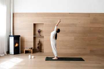 Attractive woman standing in Hasta Uttanasana pose, deflection back