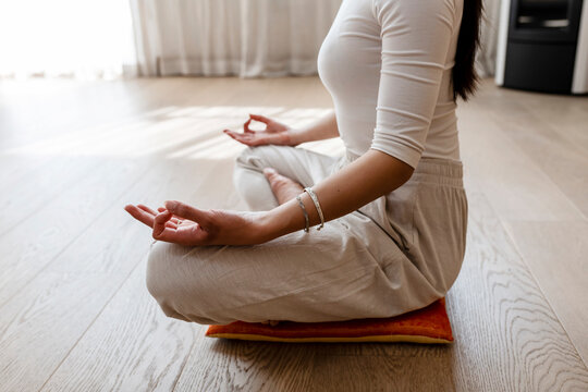 Asian woman exercising and sitting in yoga lotus position