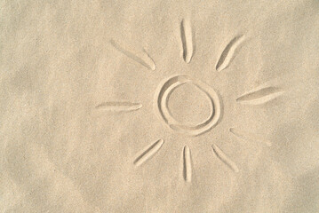 Sun drawn on the sand with copy space,Summer concept