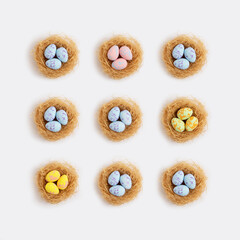 Pattern pastel easter eggs in nests on a white background. Minimal creative concept of Easter.