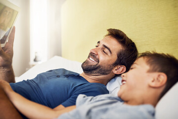 Nothing connects quite like technology does. Shot of a young man using a digital tablet with his son at home.