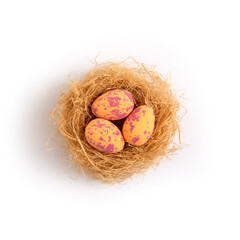 Orange pastel easter eggs in nests on a white background. Minimal creative concept of Easter.