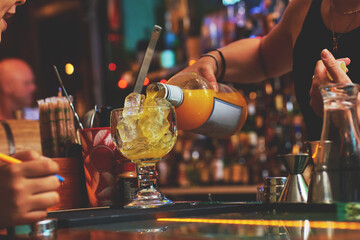 Female barman preparing drinks. cocktail bar Drinks at the bar. Fresh and cold drinks in a bar. Watermelon drink, jamiaca drink, margarita, micheladas.