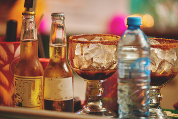 Female barman preparing drinks. cocktail bar Drinks at the bar. Fresh and cold drinks in a bar. Watermelon drink, jamiaca drink, margarita, micheladas.