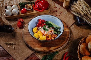 A plate with salted, pickled vegetables and mushrooms. Top view