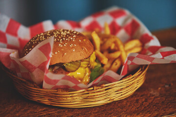 rich freshly prepared hamburger with restaurant french fries.