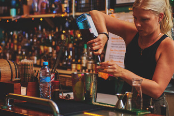 Female barman preparing drinks. cocktail bar Drinks at the bar. Fresh and cold drinks in a bar. Watermelon drink, jamiaca drink, margarita, micheladas.