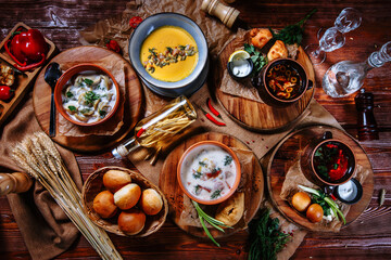 A table on which there are traditional Ukrainian dishes. Dumplings, pumpkin soup and solyanka. Top view