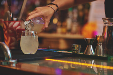 Female barman preparing drinks. cocktail bar Drinks at the bar. Fresh and cold drinks in a bar. Watermelon drink, jamiaca drink, margarita, micheladas.
