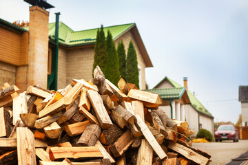 A pile of split firewood for heating the house.