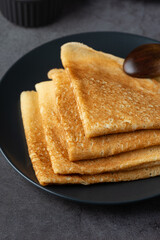 Stack of thin pancakes in a plate