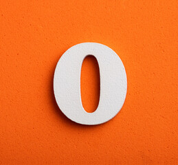 number zero - white number in wood on orange background