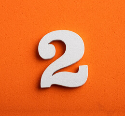 Number two - white number in wood on orange background