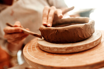 Its fun and rewarding to turn a piece of clay into art. Cropped shot of a woman shaping a clay pot...