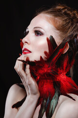 Caucasian ginger model with fantasy feathers makeup 