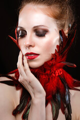 Caucasian ginger model with fantasy feathers makeup 