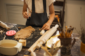 Close up image of girl hands works with clay. 