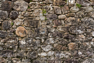 Close up view of an old stone wall. Texture of a stone wall.