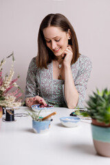Portrait of artisan woman making handmade gemstone jewellery, home workshop. Women artisan creates jewellery. Art, hobby, handcraft concept