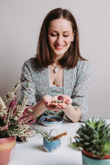 Portrait of artisan woman making handmade gemstone jewellery, home workshop. Women artisan creates jewellery. Art, hobby, handcraft concept