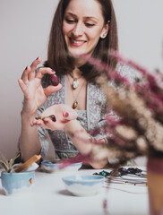 Portrait of artisan woman making handmade gemstone jewellery, home workshop. Women artisan creates jewellery. Art, hobby, handcraft concept