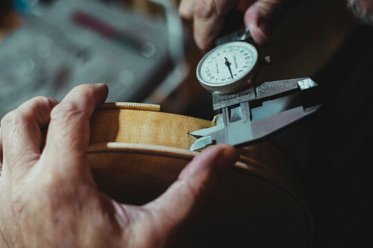 Violin maker handling luthier tools for woodcarving