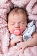 Beautiful Newborn baby girl sleeping , pink background	
