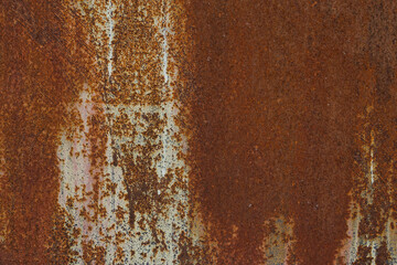 Macro fragment of the dark worn rusty metal wall texture, grunge background.