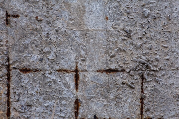 Macro fragment of an old gray concrete wall with rusty rebar. Material aged, construction. Brutal background.