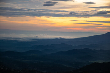 Fototapeta na wymiar colorful sunrise at the highest peak of Mount Si Kunir, Mount Dieng, Wonosobo, Indonesia 