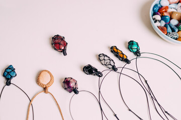 Collection of various raw mineral gemstones with handmade necklaces