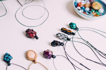 Collection of various raw mineral gemstones with handmade necklaces
