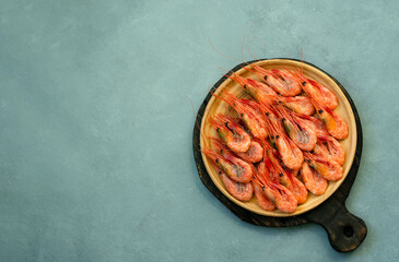 Shrimps on a white plate, against the background