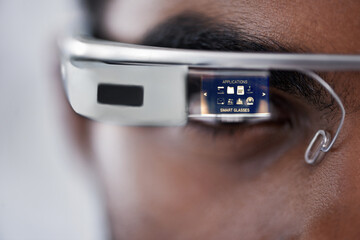 Taking a closer look. Closeup shot of a young man using smartglasses to browse the web.