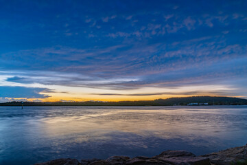 Fototapeta premium Sunrise by the bay with stratocumulus clouds