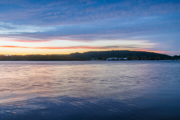 Fototapeta premium Sunrise by the bay with stratocumulus clouds