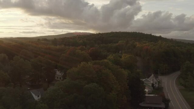 Autumn colors set in around Monson Town. Maine Aerial along road