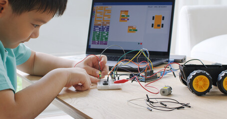 Asia home school young small kid happy smile self study online lesson excited make AI circuit toy....