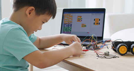 Asia home school young small kid happy smile self study online lesson excited make AI circuit toy....