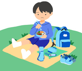 外でお弁当を食べている男の子