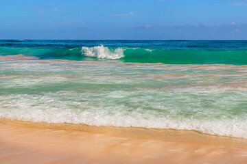 Tropical beach background, golden sand and azure shore water under blue sky. Caribbean Sea coast, Dominican republic, Punta Cana