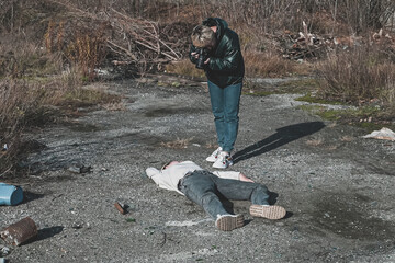 a female forensic expert photographs the body of a dead homeless girl who died in a car accident on