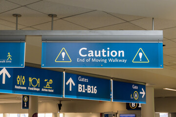 International Airport sign Caution End of Moving Walkway in air terminal