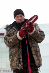 Portrait of a fitter in a winter jacket with a tape rag sling